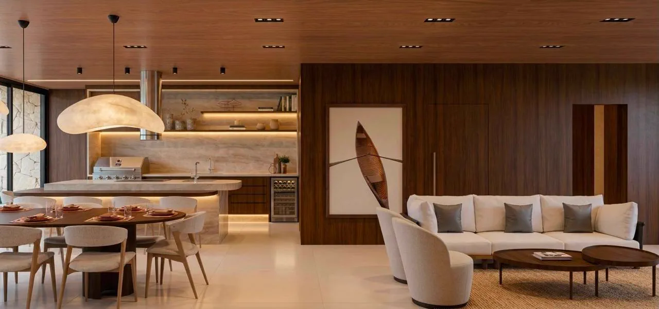 Living integrado à cozinha, com luminárias em forma de nuvem e quadro de canoa